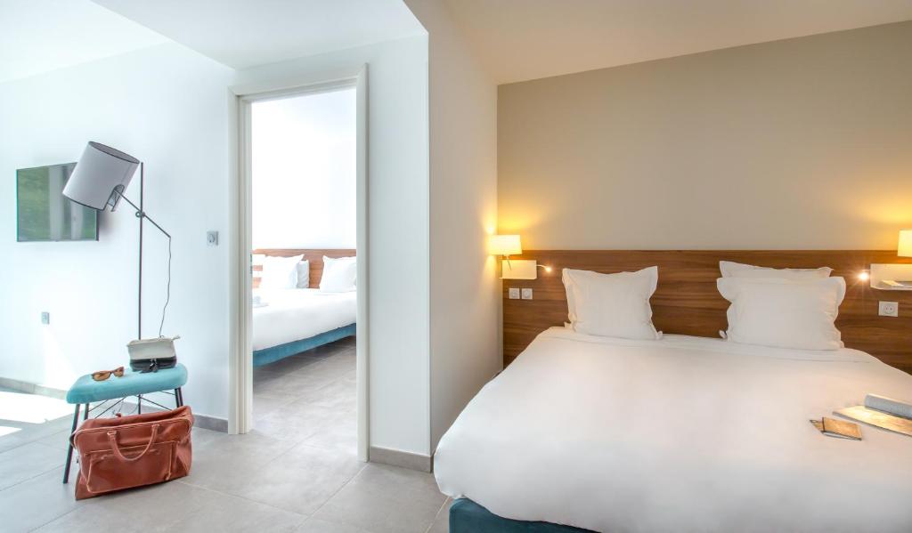 Postel nebo postele na pokoji v ubytování SOWELL HOTELS La Plage