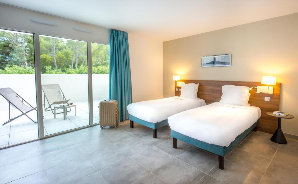 Postel nebo postele na pokoji v ubytování SOWELL HOTELS La Plage