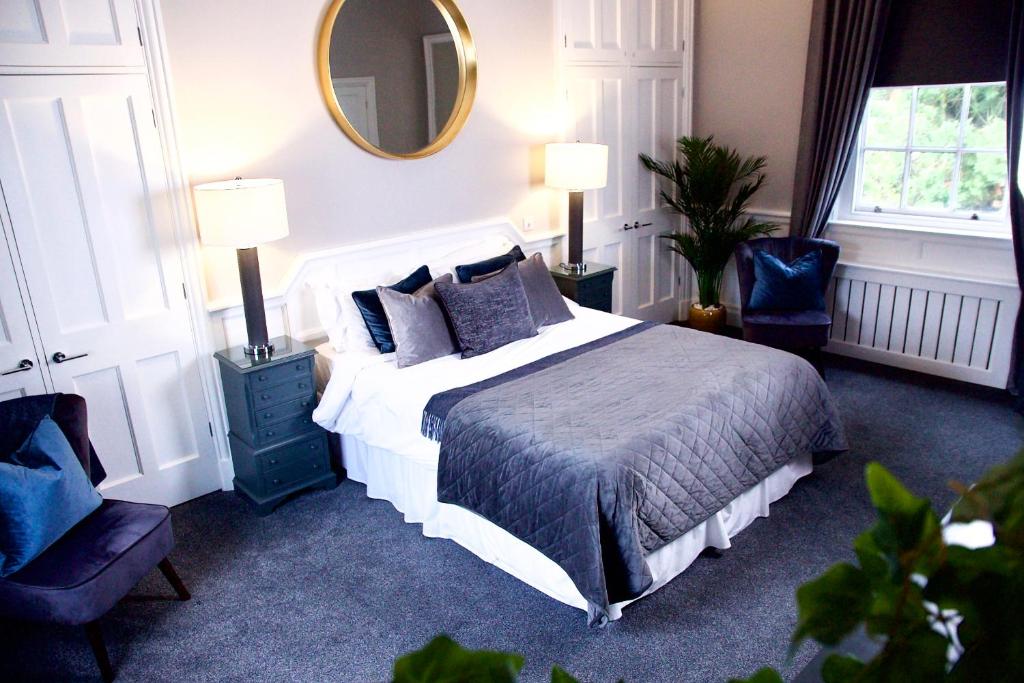a bedroom with a large bed and a mirror at J.D.Young in Harleston