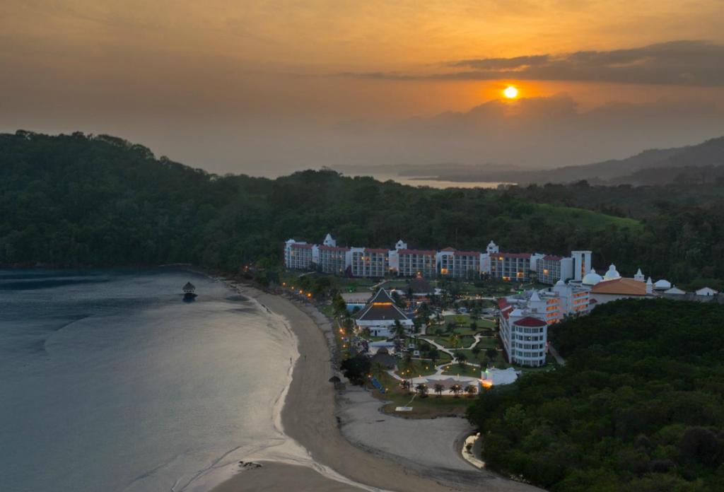 a view of a resort on the beach at sunset at Dreams Playa Bonita All Inclusive in Playa Bonita Village