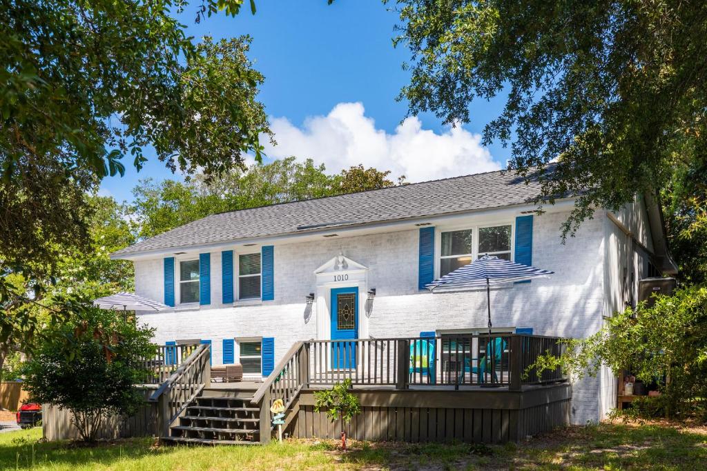 a house with a blue door and a porch at 1010 E Ashley - Two Kitchens - Steps to Beach in Folly Beach