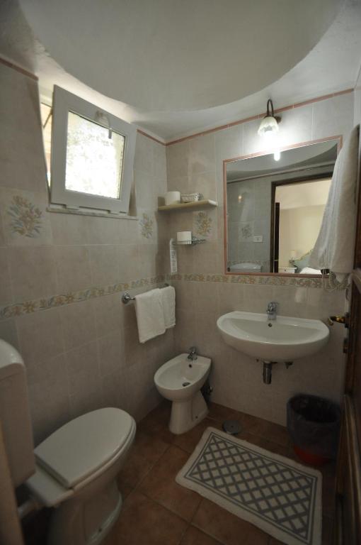 a bathroom with a toilet and a sink at Villa Eva in Anacapri