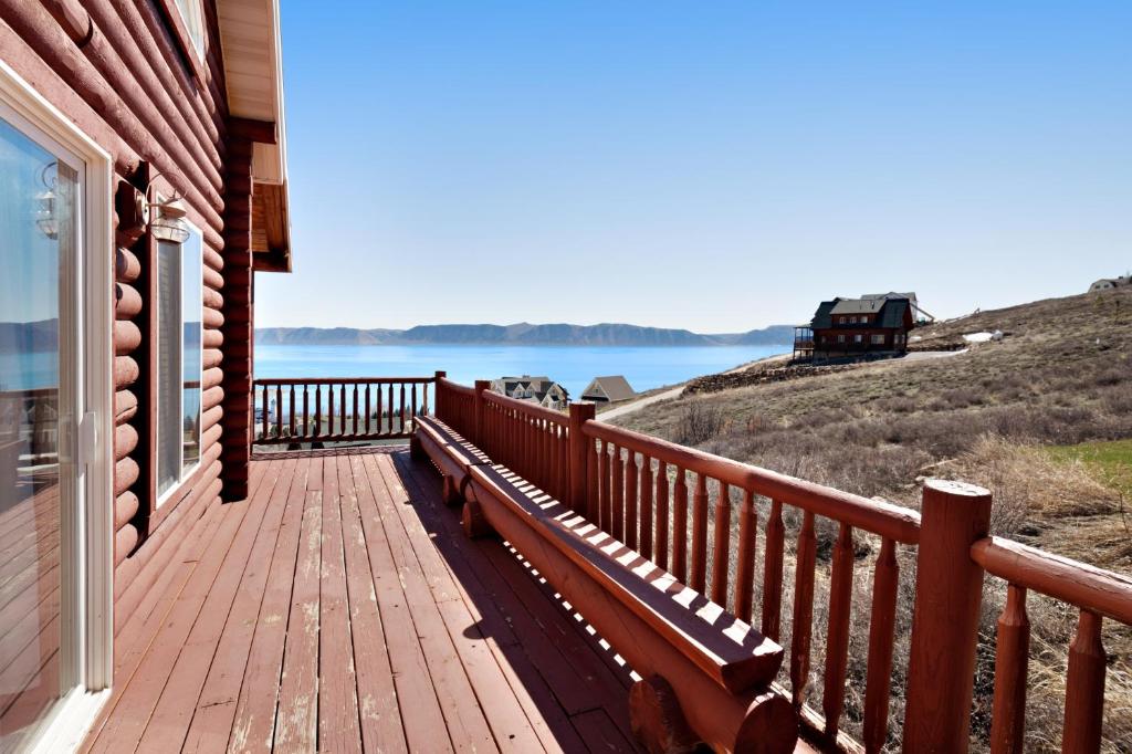 a wooden deck on a house with a view of the water at Worthen Cabin in Garden City