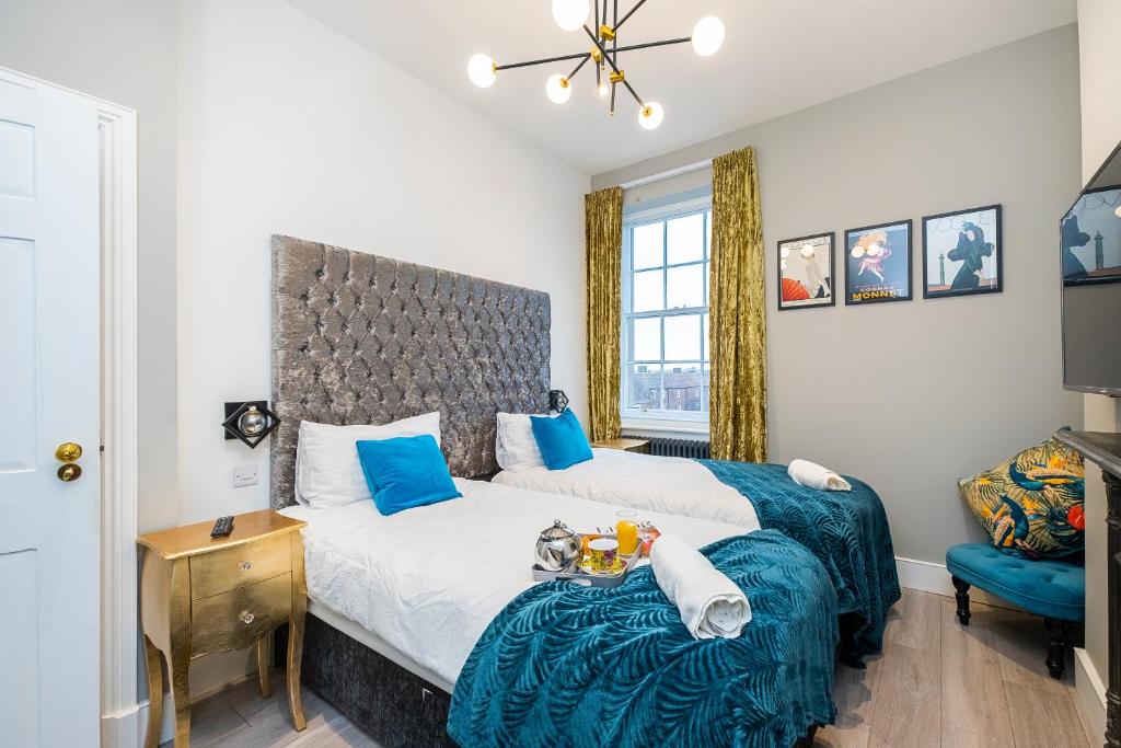 a bedroom with a king sized bed and a chair at King Square Serviced Apartments in Bridgwater