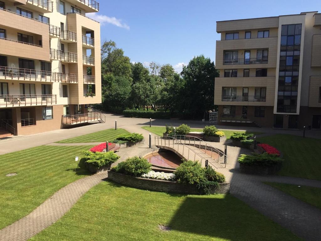 a park in front of a large building at Lux Apartment in Druskininkai