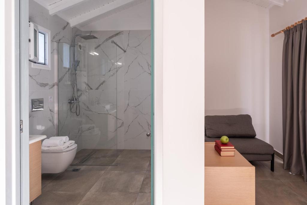a bathroom with a shower and a toilet and a sink at Eutopia Olive Garden in Syvota