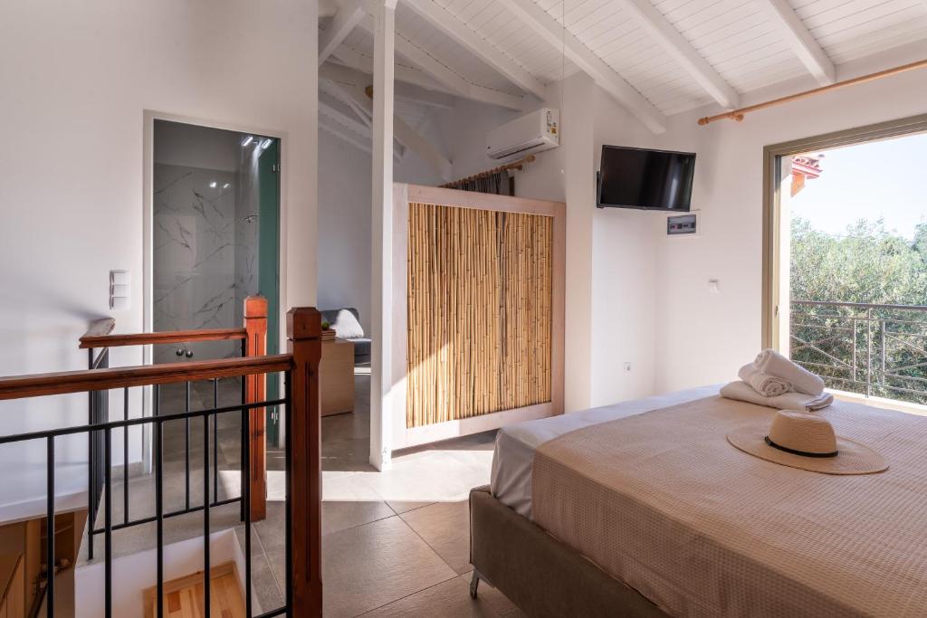 a bedroom with a bed with a hat on it at Eutopia Olive Garden in Syvota