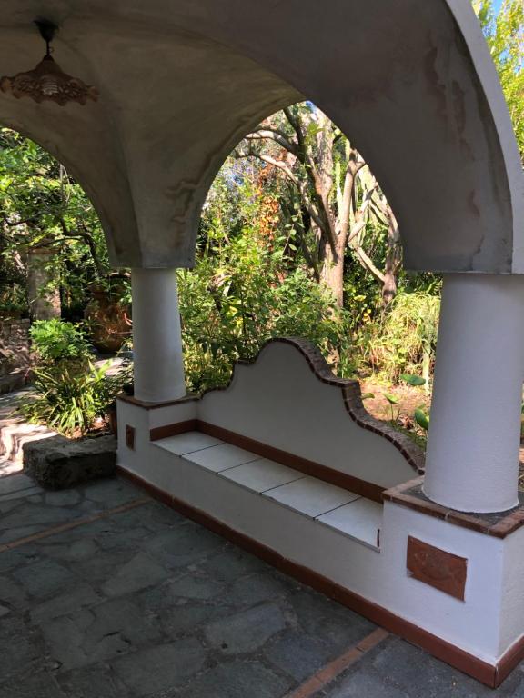 an archway with a bench in a garden at Villa Eva in Anacapri