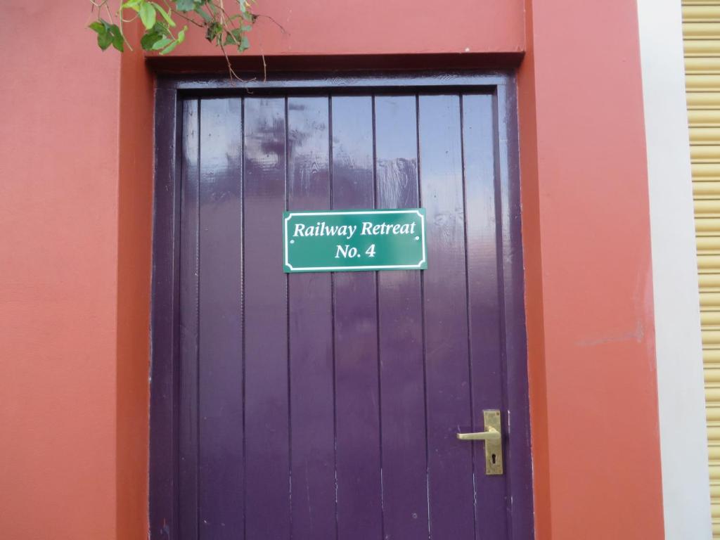 a purple door with a sign on it at Railway Retreat No4 Comberton Terrace in Kidderminster