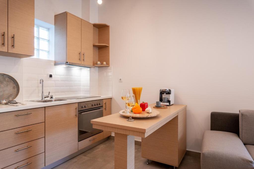 a kitchen with a table with a bowl of fruit on it at Eutopia Olive Garden in Syvota