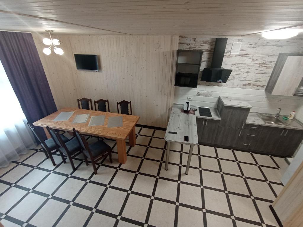 a kitchen with a table and chairs and a sink at Приватна садиба Соломія in Bukovel