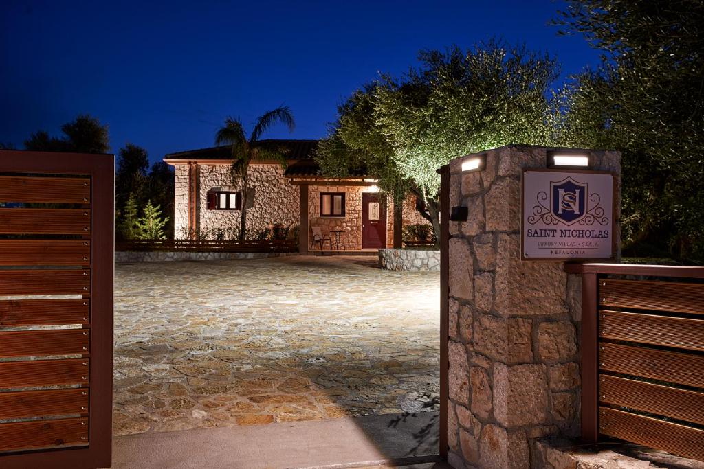 a gate to a house with a sign in front of it at Saint Nicholas Villas in Skala Kefalonias