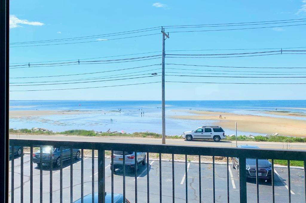 a view of a parking lot with a view of the beach at Harbor Hotel Provincetown in Provincetown