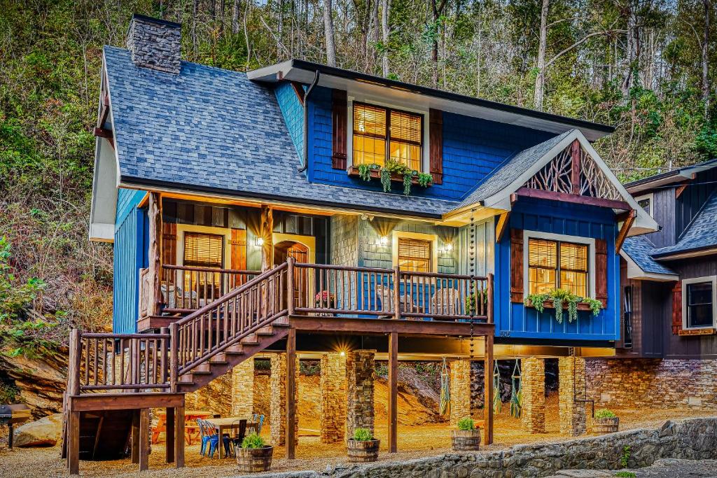 a large blue house with a deck and stairs at The Blue Spruce in Gatlinburg