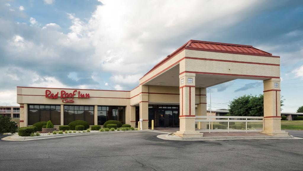 a building with a red roof inn sign in a parking lot at Red Roof Inn & Suites Wytheville in Wytheville