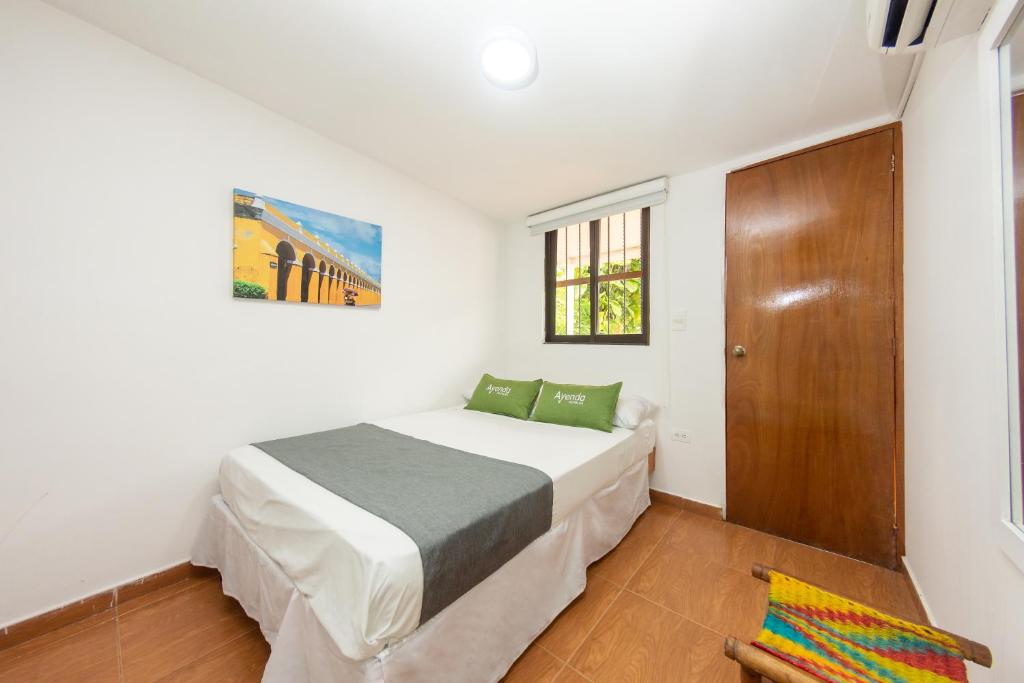 Postel nebo postele na pokoji v ubytování Hotel Ayenda Casa Cano 1805