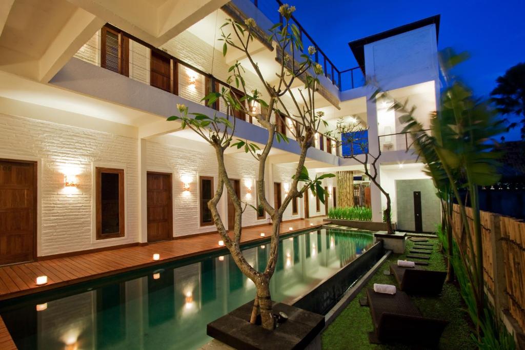 a villa with a swimming pool at night at Echoland Boutique Bed And Breakfast in Canggu