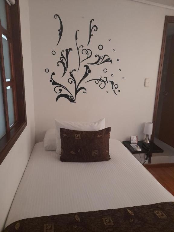 Postel nebo postele na pokoji v ubytování Hotel Confort Bogota