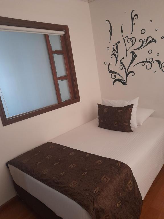 Postel nebo postele na pokoji v ubytování Hotel Confort Bogota