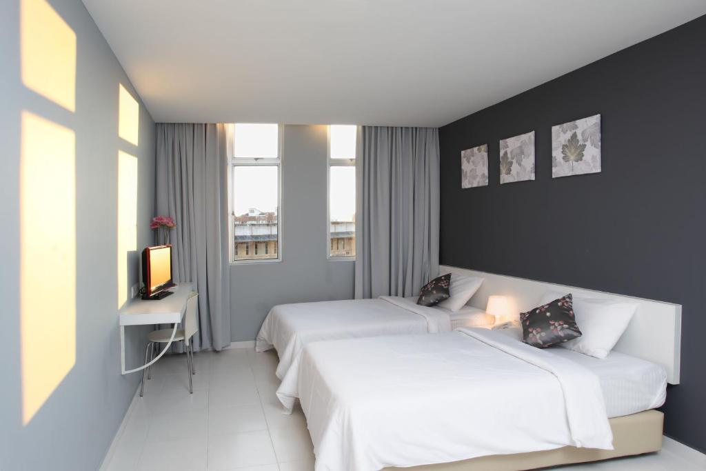 Postel nebo postele na pokoji v ubytování Wan Loong Hotel