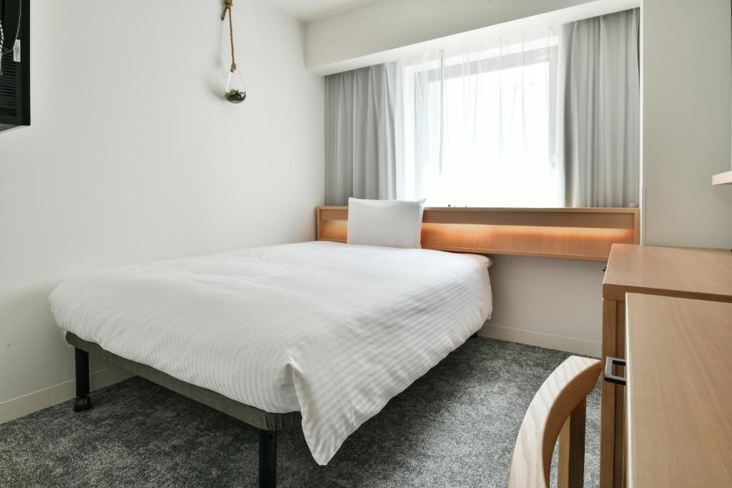 Postel nebo postele na pokoji v ubytování REF Omiya by VESSEL HOTELS