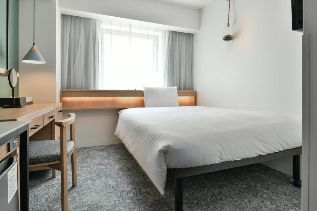 Postel nebo postele na pokoji v ubytování REF Omiya by VESSEL HOTELS
