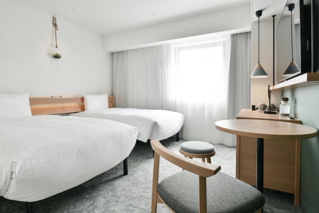 Postel nebo postele na pokoji v ubytování REF Omiya by VESSEL HOTELS