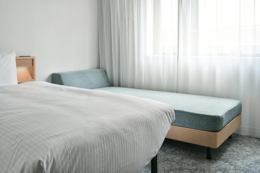Postel nebo postele na pokoji v ubytování REF Omiya by VESSEL HOTELS