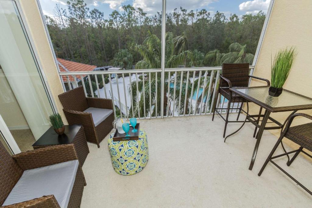 a balcony with a table and chairs and a view at Coral Falls- Celeste Dr./Lely in Belle Meade