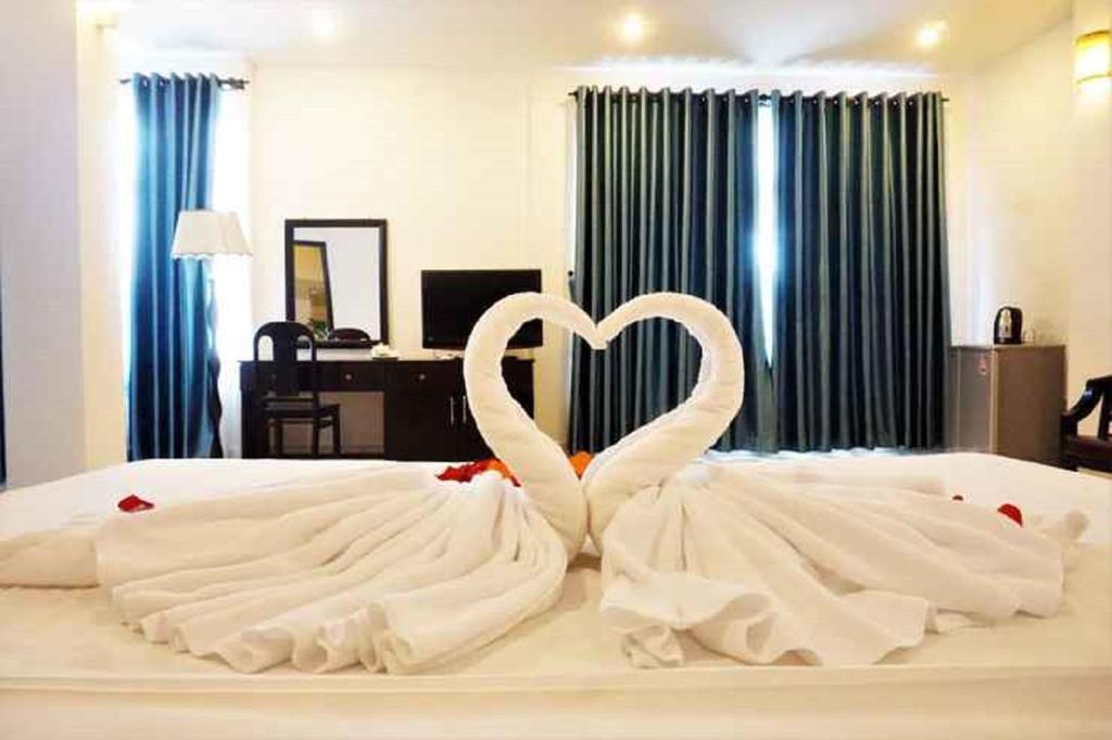 Postel nebo postele na pokoji v ubytování Tehana Beach Hotel Da Nang