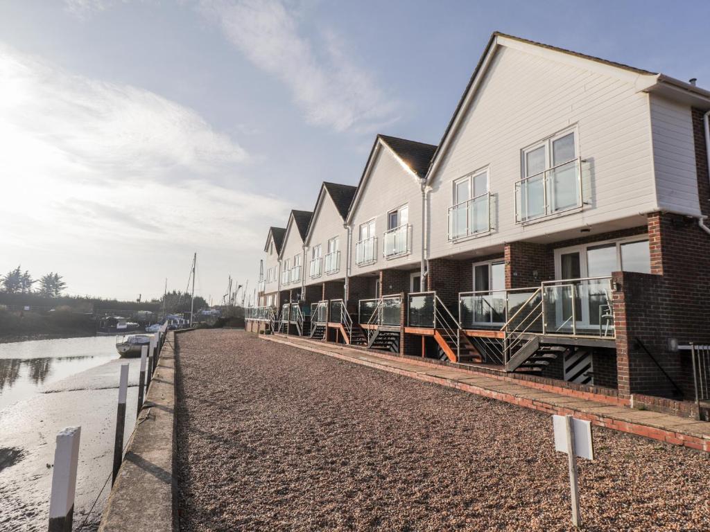 a row of houses on the side of a river at 3 Tidal in Rye