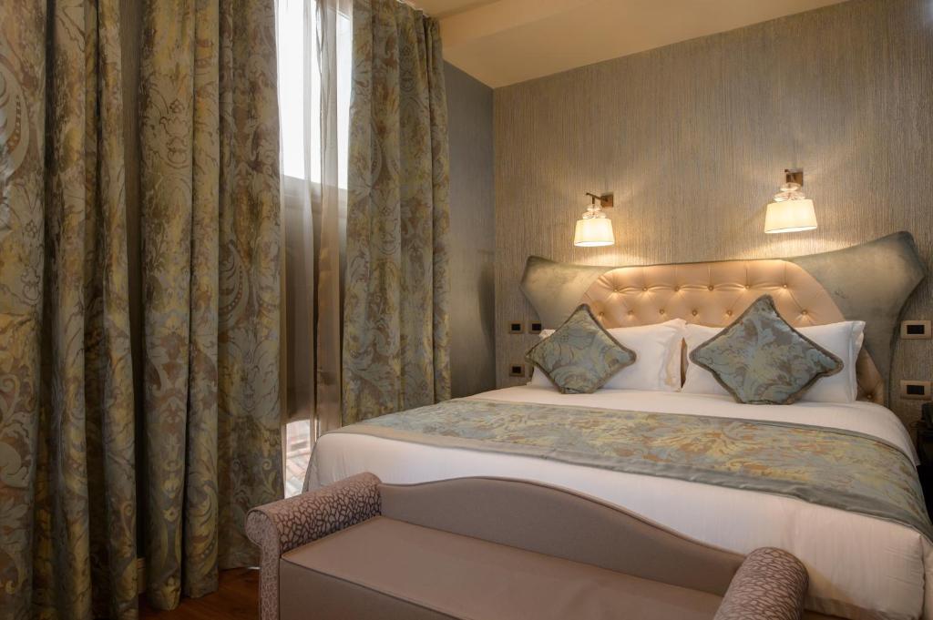 a bedroom with a large bed and a window at Palazzo Veneziano - Venice Collection in Venice