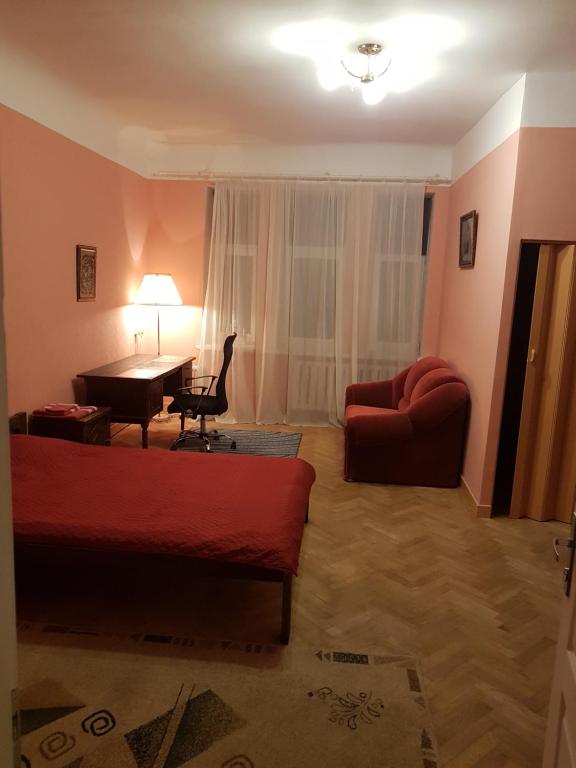 a room with a bed and a desk and a couch at EBU 28 in Rīga