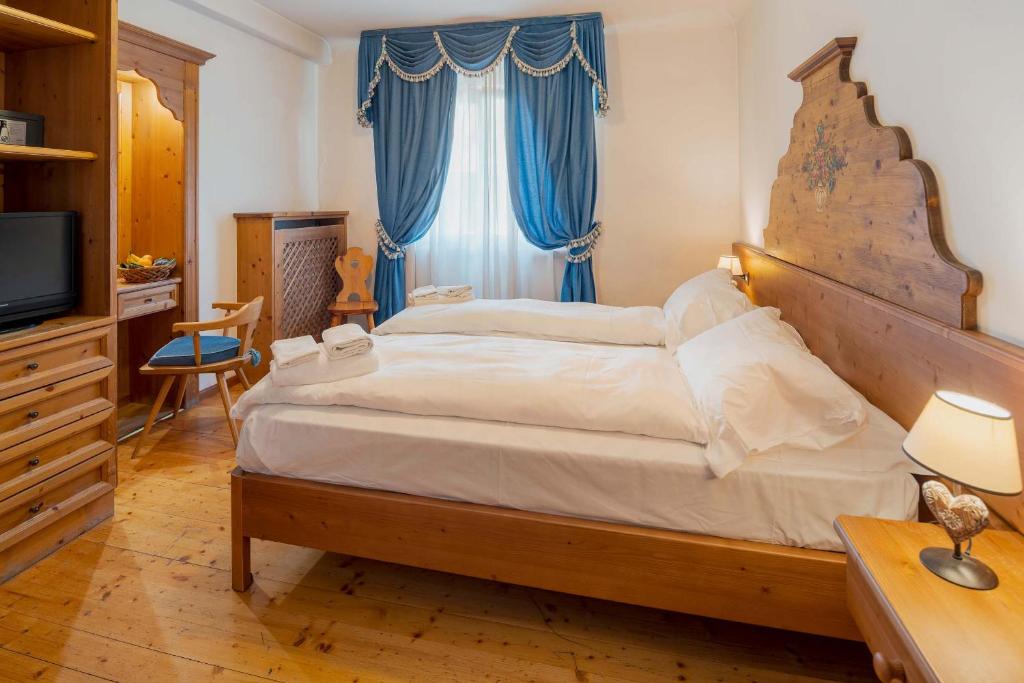 Кровать или кровати в номере Royal Hotel Cortina