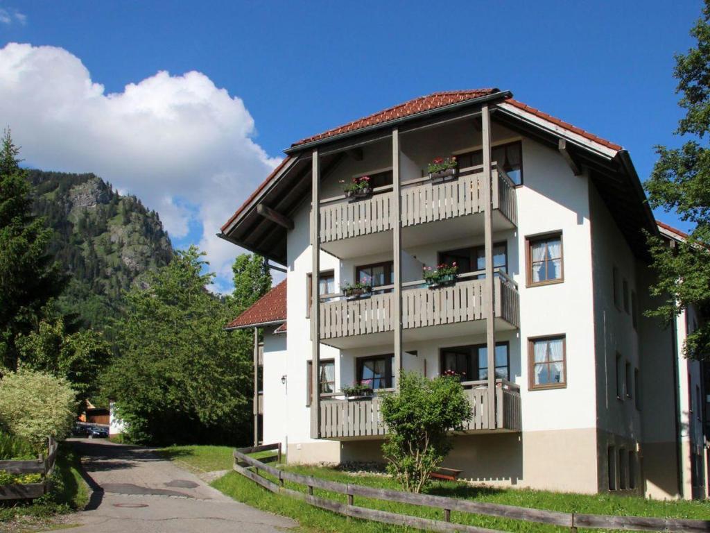 a building with balconies and flowers on it at Allgaeublick-App23-Gaestehaus-in-Bad-Hindelang in Bad Hindelang