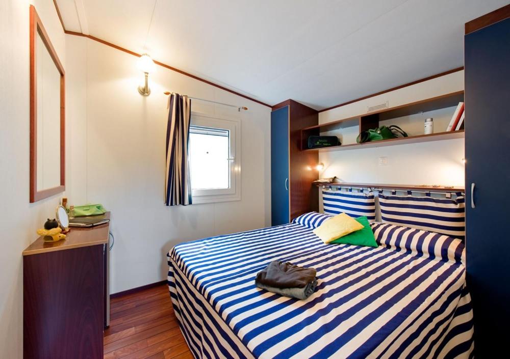 Łóżko lub łóżka w pokoju w obiekcie Camping Village Rosselba Le Palme