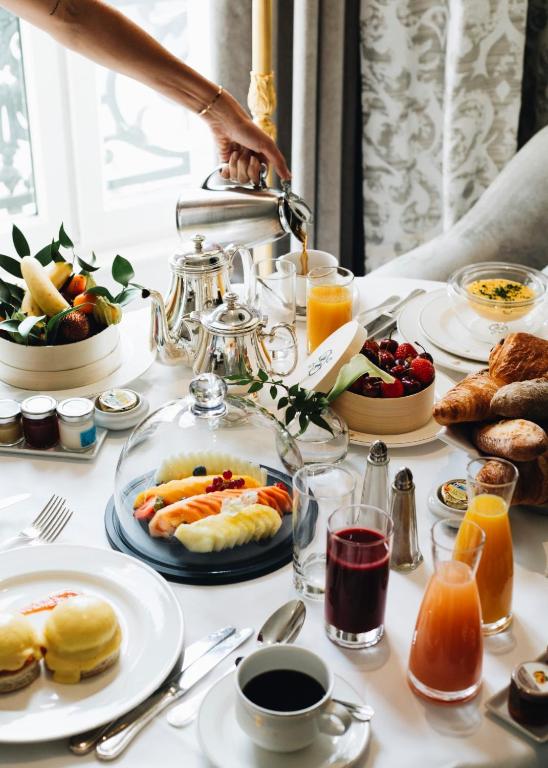 a table full of breakfast foods and drinks at InterContinental Paris Le Grand by IHG in Paris