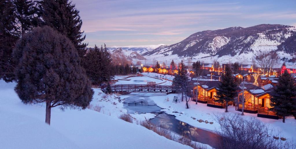 a town in the snow with a bridge and buildings at Rustic Inn Creekside in Jackson