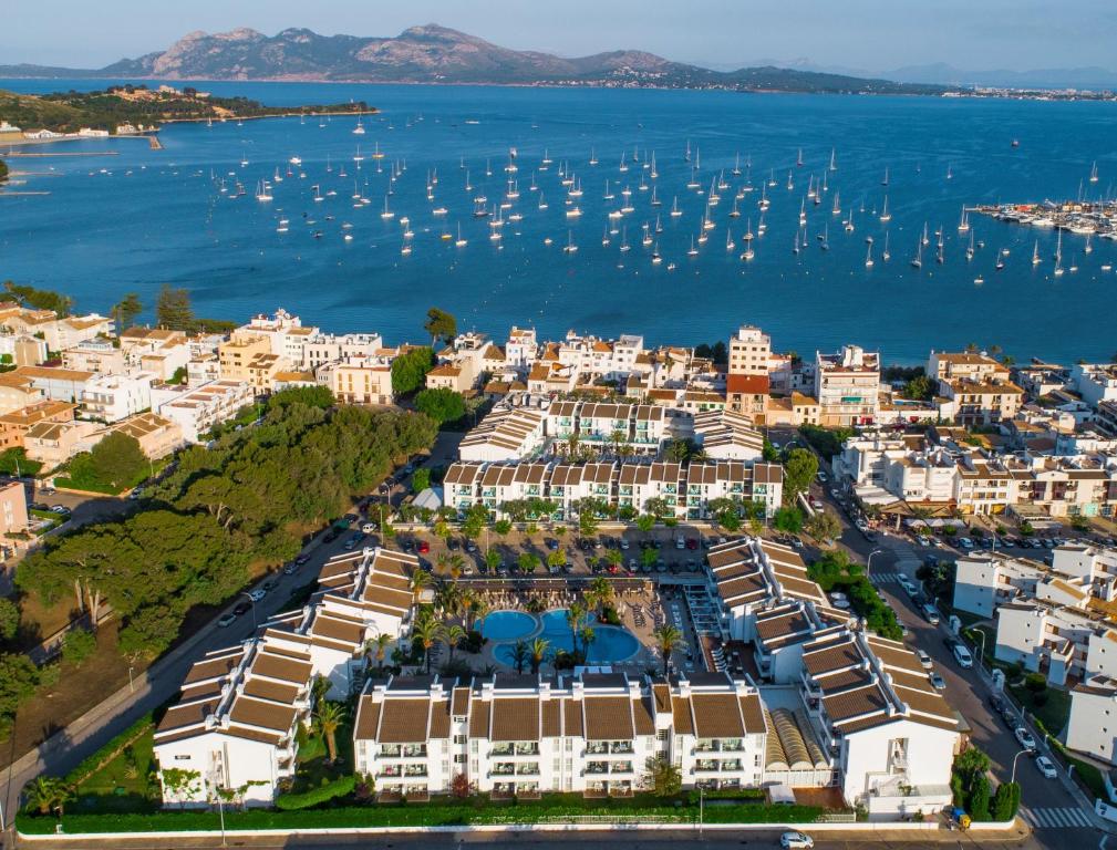 an aerial view of a city with boats in the water at Puerto Azul Suite Hotel in Port de Pollensa