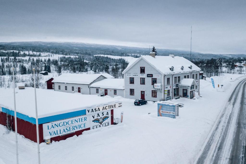 a town covered in snow with a building and a road at Vasacenter B&B in Transtrand