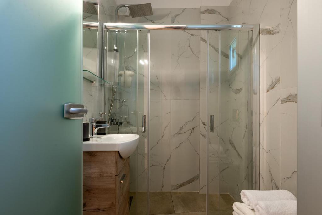 a bathroom with a shower and a sink at Eutopia Olive Garden in Syvota