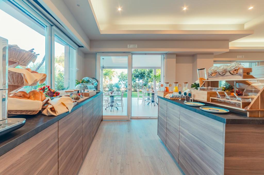 a large kitchen with wooden counters and glass doors at Hotel Rivage Taormina in Taormina