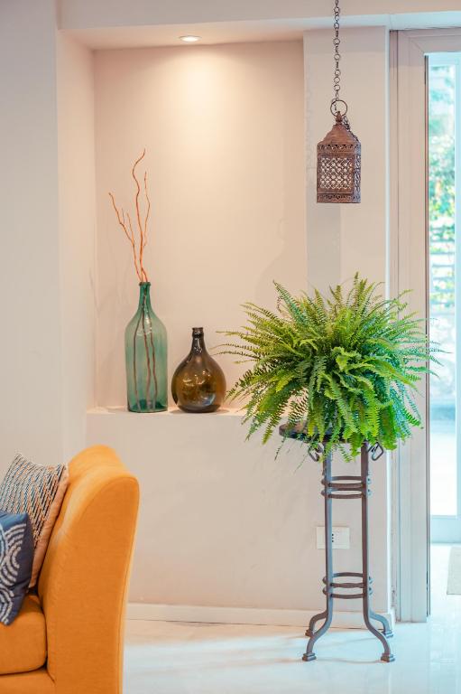a living room with a couch and a potted plant at Hotel Rivage Taormina in Taormina
