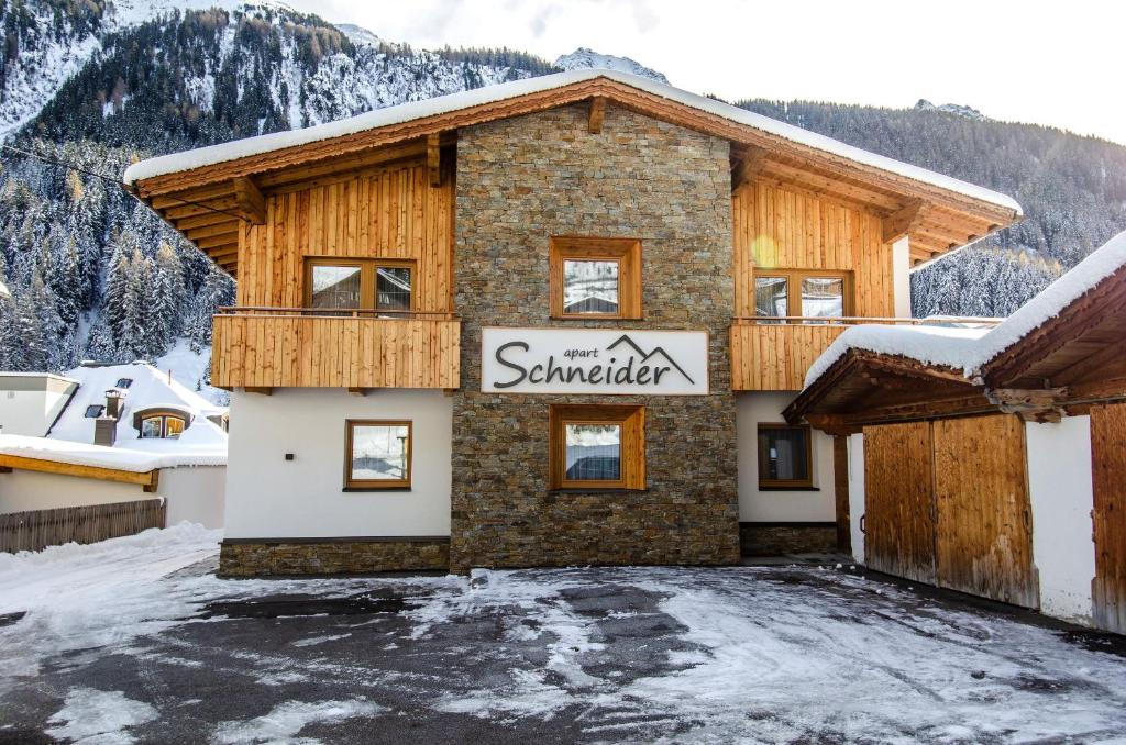 a building with a sign that reads snowmaker at Apart Schneider in Ischgl