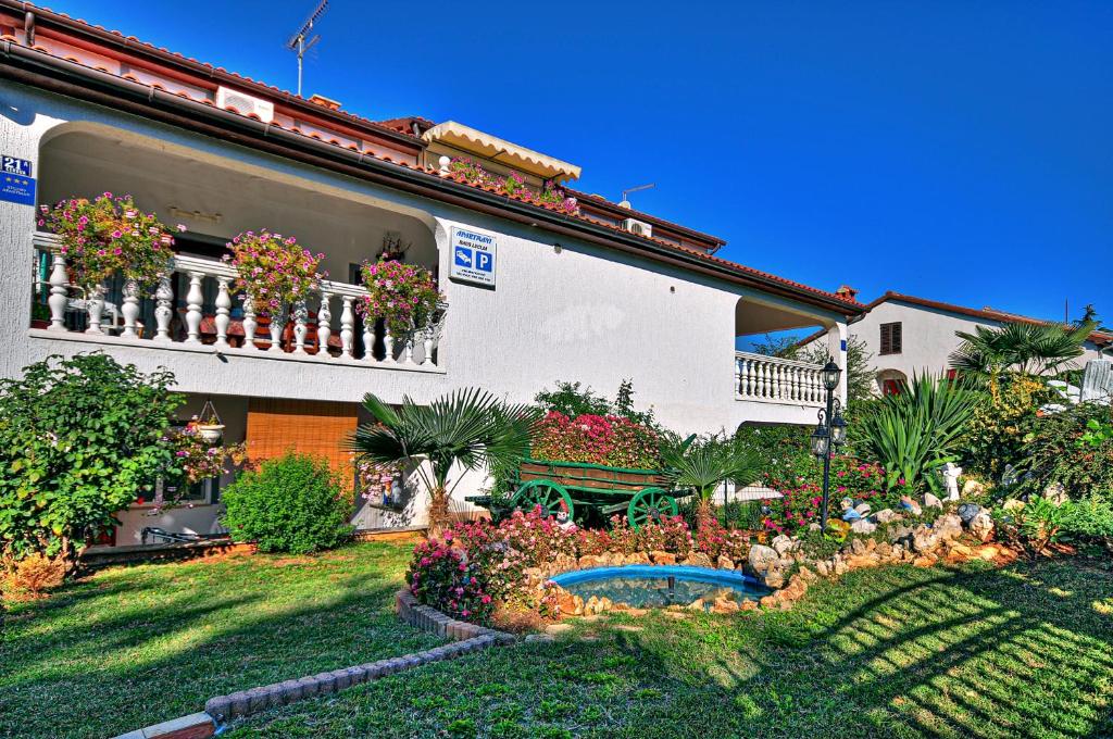 a garden in front of a building with a bench at House Lucija in Poreč