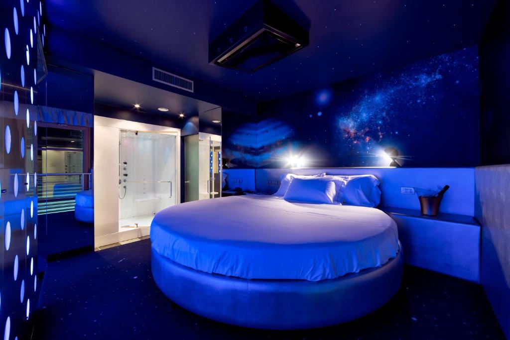 um quarto azul com uma cama grande e um tecto azul em Motel Hotel Piranha em Cameriano