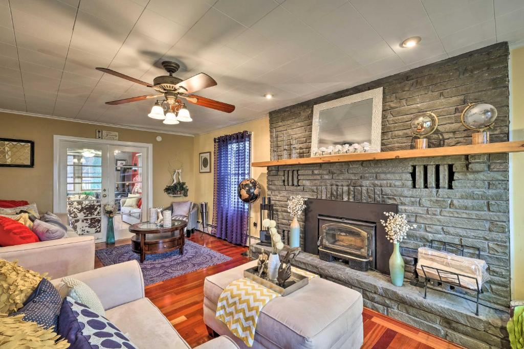 a living room with a brick fireplace at Stylish Suburban Getaway, 10 Miles to Royal Mtn! in Johnstown