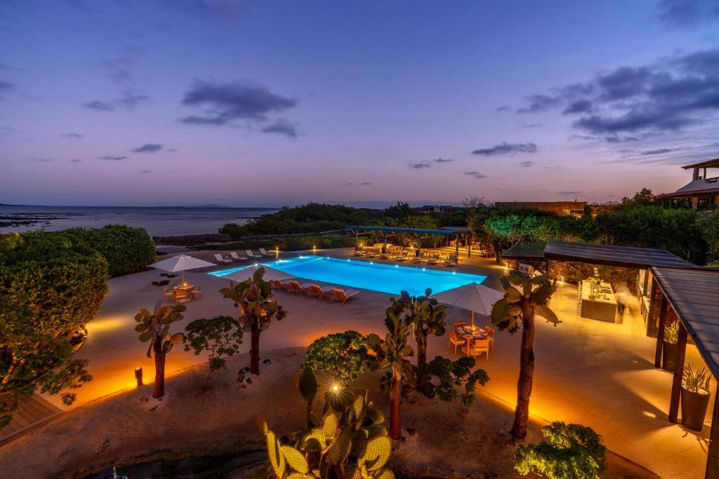 an overhead view of a swimming pool at night at Finch Bay Galapagos Hotel in Puerto Ayora