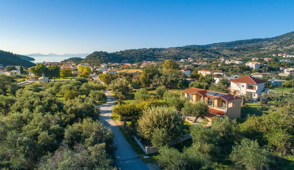 an aerial view of a small town with a river at Eutopia Olive Garden in Syvota