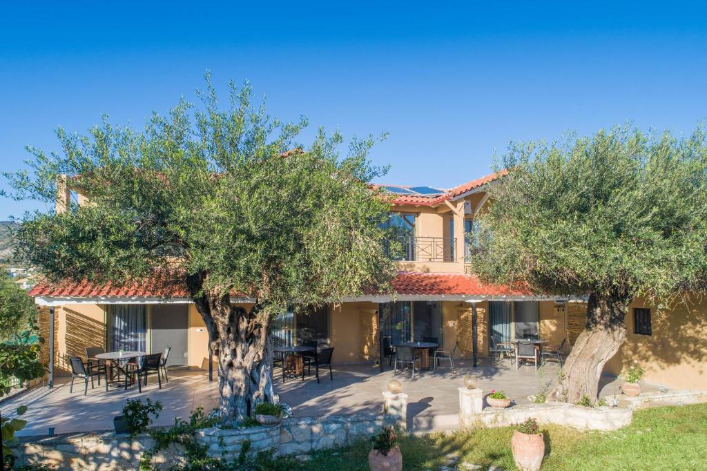 a house with two trees and a patio at Eutopia Olive Garden in Syvota